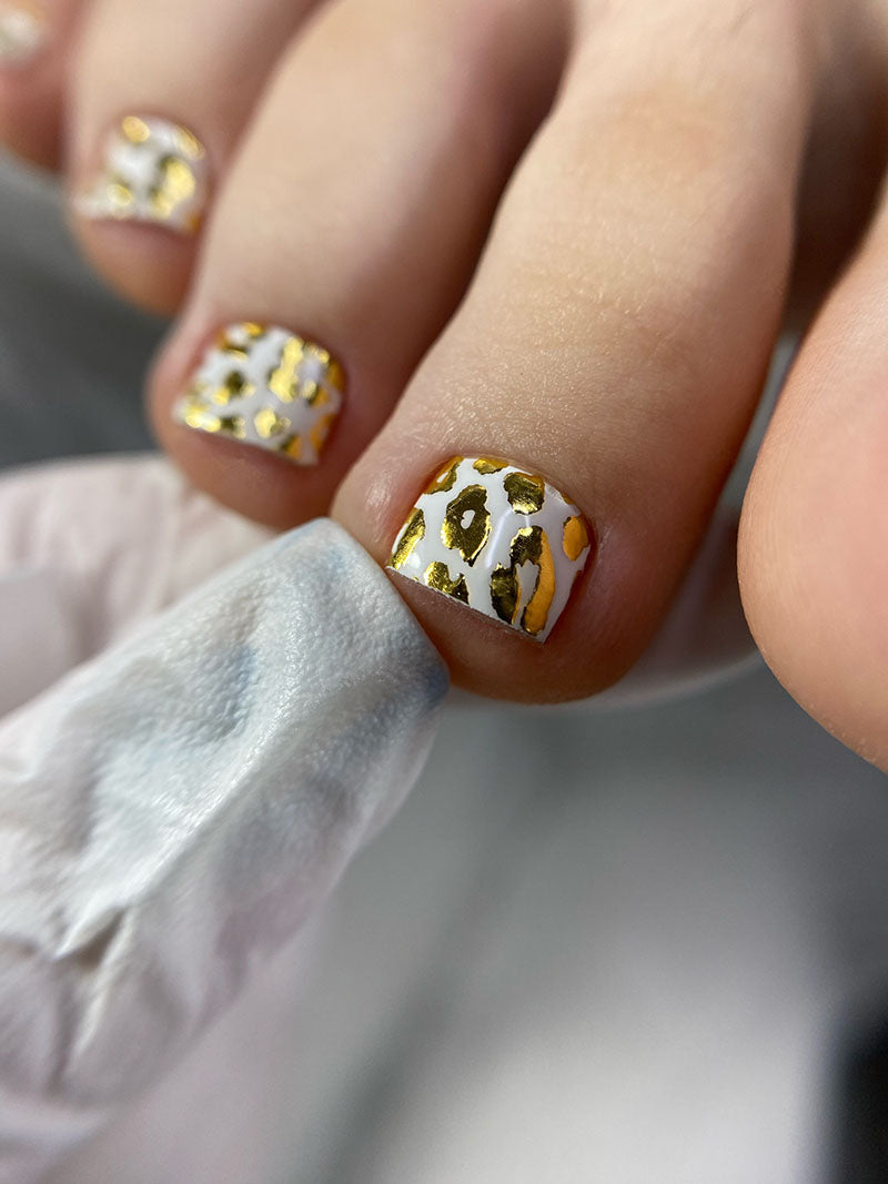 Pedicure Leo. White background. Foil gold. Nail wrap WR-839