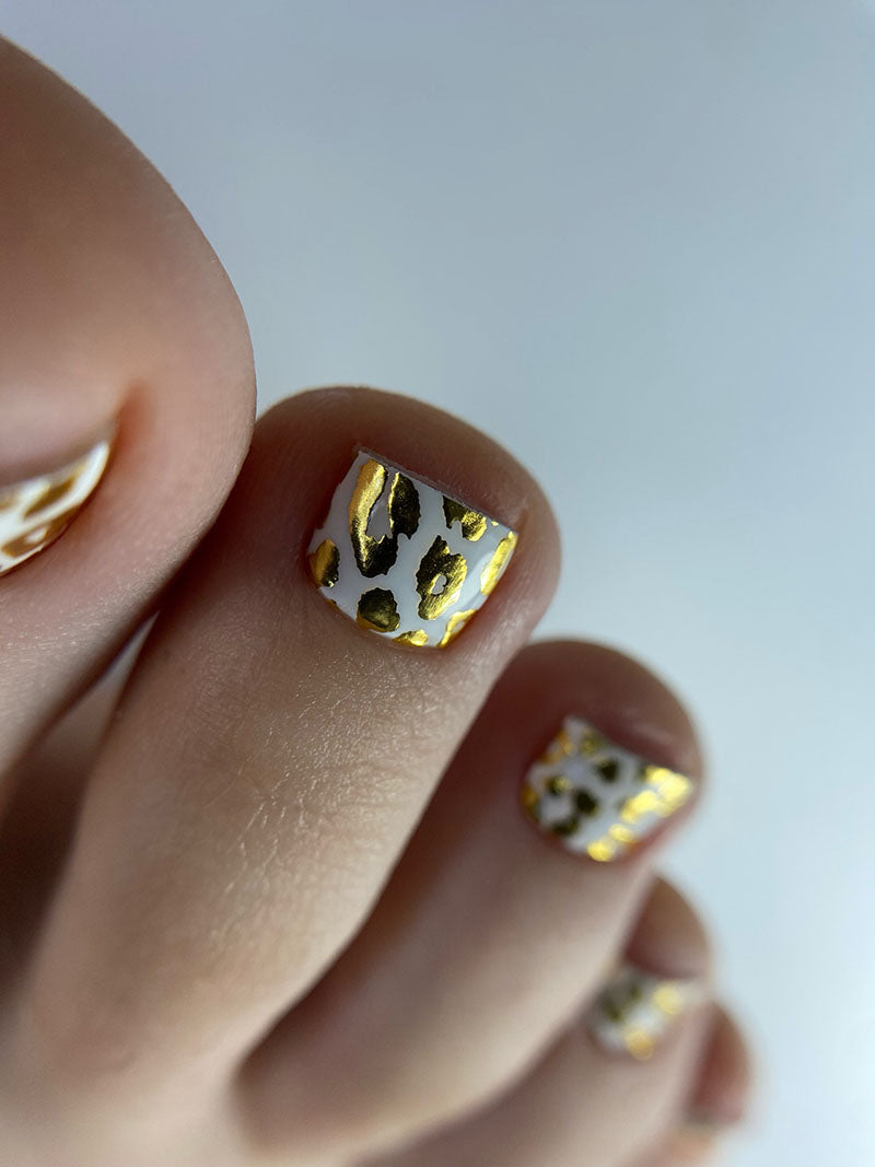 Pedicure Leo. White background. Foil gold. Nail wrap WR-839