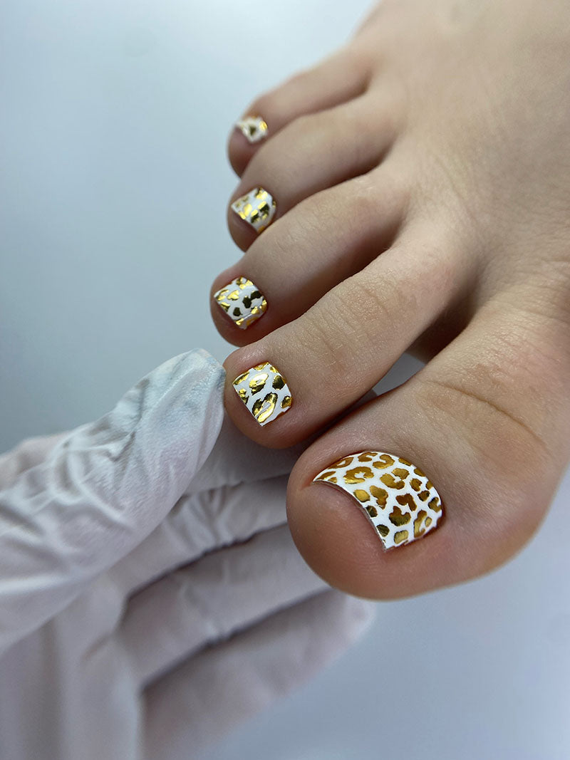 Pedicure Leo. White background. Foil gold. Nail wrap WR-839